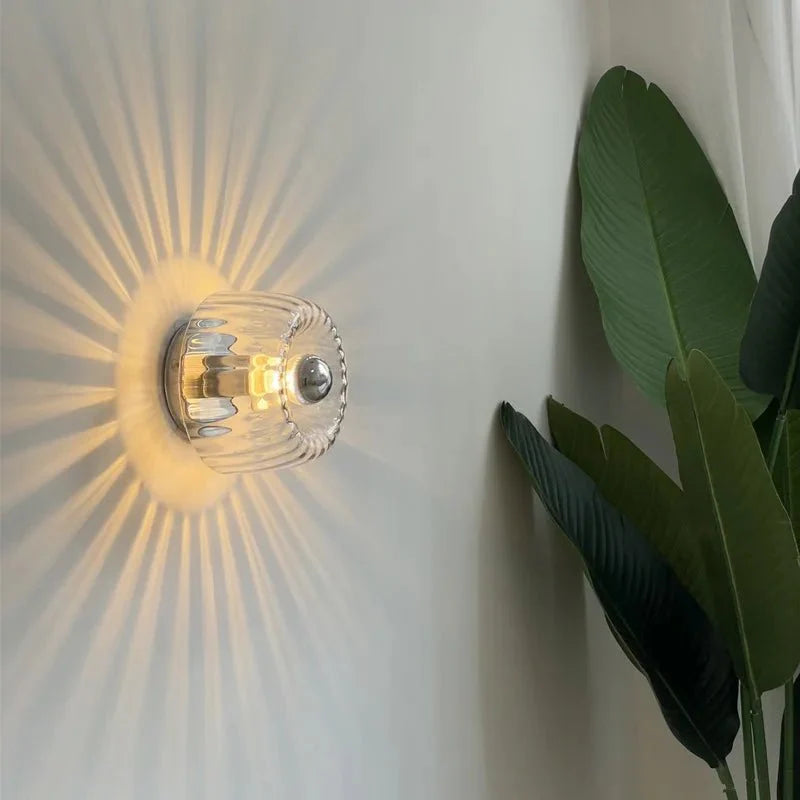 Australum Sol sconce close-up showing ribbed glass detail