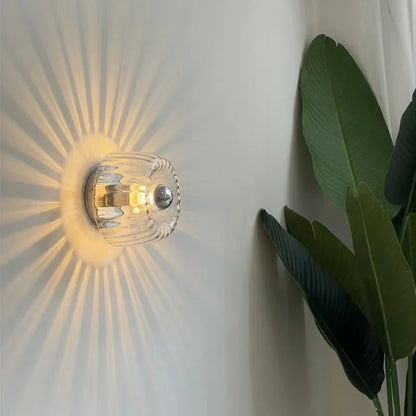 Australum Sol sconce close-up showing ribbed glass detail